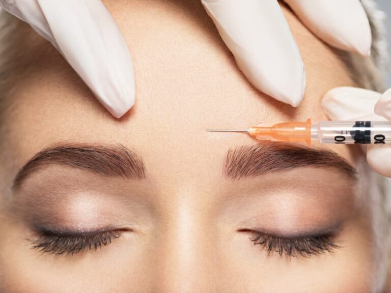 Close-up of a woman receiving a BOTOX® forehead injection to smooth fine lines and maintain a youthful, refreshed appearance.