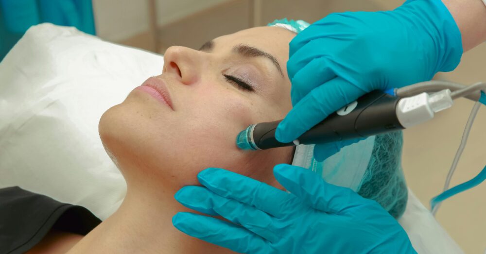 Provider performing a skin treatment on a female client