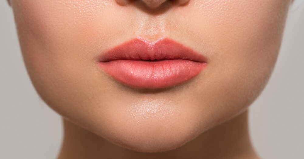 Close-up of a woman's full, naturally enhanced lips after a lip filler treatment