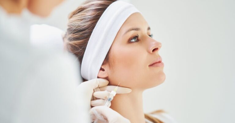 A woman receiving a Botox injection along the jawline