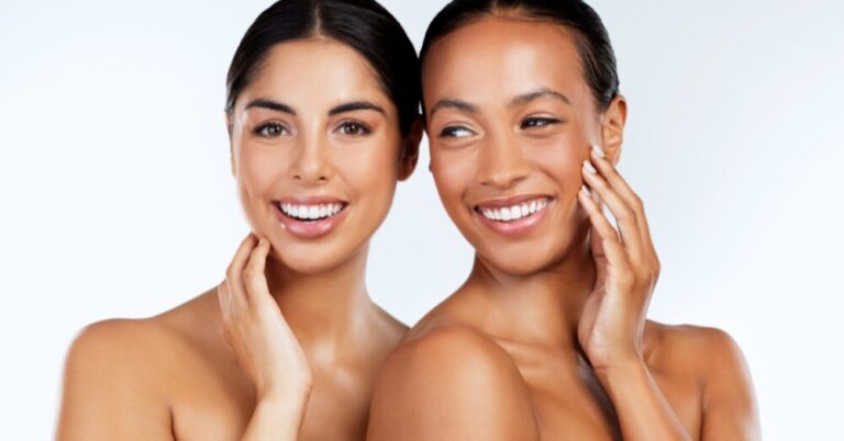 Two women smiling with clear, glowing skin