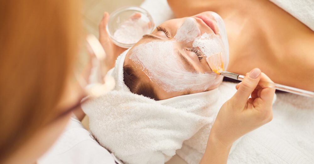 Woman receiving a facial from a provider in a relaxing environment