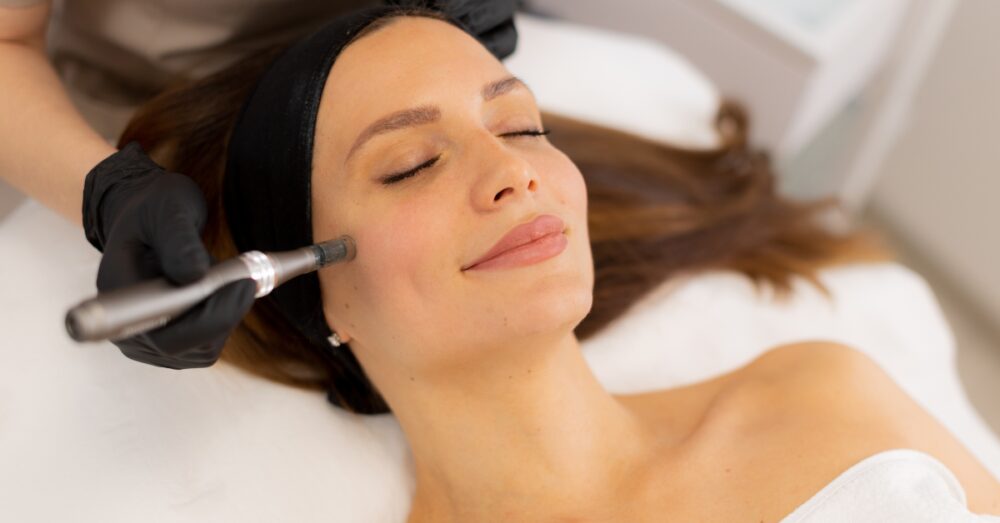 Woman receiving a microneedling treatment near her under eye area